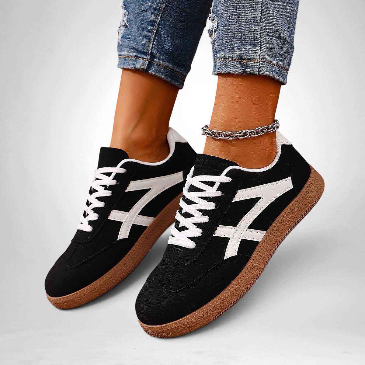 ZOFIA ATELIER black and white color-block sneakers with a gum sole, lace-up closure, and mesh inner lining.
