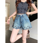 ZOFIA ATELIER blue denim shorts with embroidered floral trim and scalloped hem. Mid-rise waist.