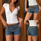 ZOFIA ATELIER blue denim hot pants with mid-to-low waist and distressed details. Stretch cotton blend.