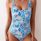 ZOFIA ATELIER Nadia backless sculpt swimsuit in a blue floral print. Features a scoop neck and high-cut legs.
