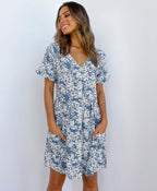 ZOFIA ATELIER blue and white floral print mini dress with V-neck, short sleeves, and pockets.