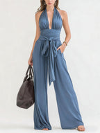 ZOFIA ATELIER blue polyester halter-neck sleeveless wide-leg jumpsuit with tie waist and plunging neckline.