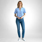ZOFIA ATELIER light blue jacquard V-neck blouse with white polka dots and button front, worn by a model with blue jeans.