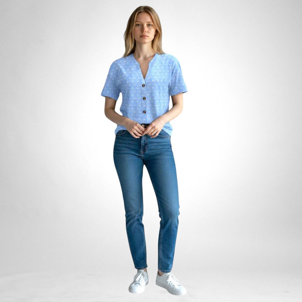 ZOFIA ATELIER light blue jacquard V-neck blouse with white polka dots and button front, worn by a model with blue jeans.