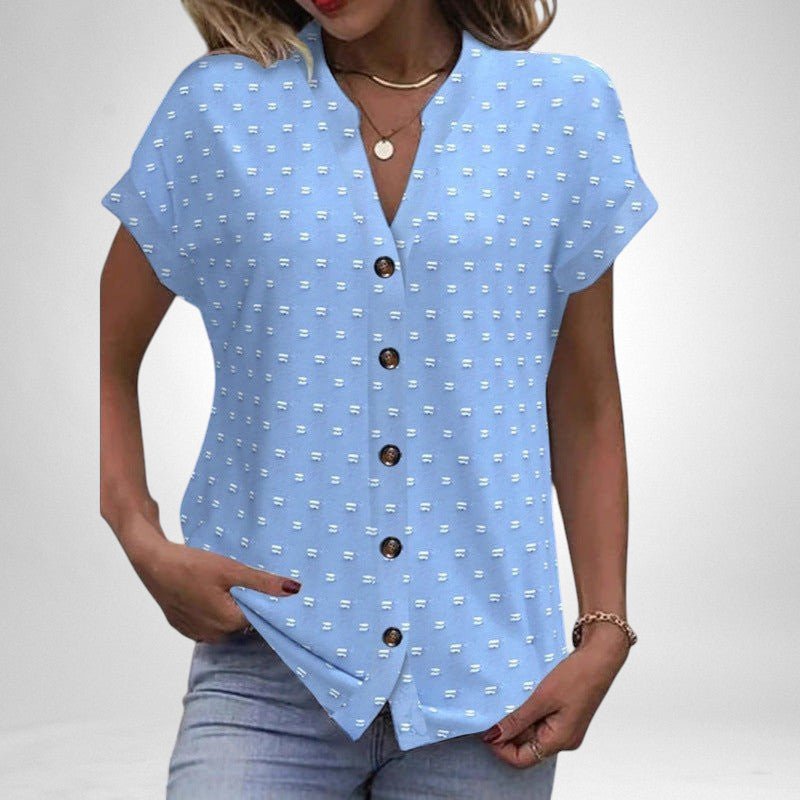 ZOFIA ATELIER light blue jacquard V-neck blouse with white dot pattern and brown buttons. Short sleeves, relaxed fit.