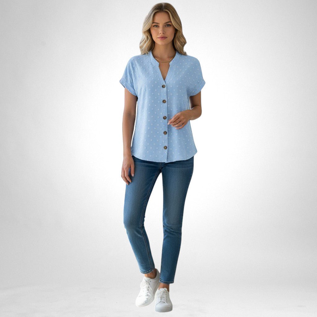 ZOFIA ATELIER light blue jacquard V-neck blouse with short sleeves and button front, paired with jeans.