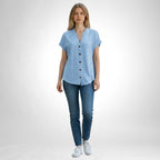 ZOFIA ATELIER light blue jacquard V-neck blouse with white dot pattern and button front, worn by a model with jeans.