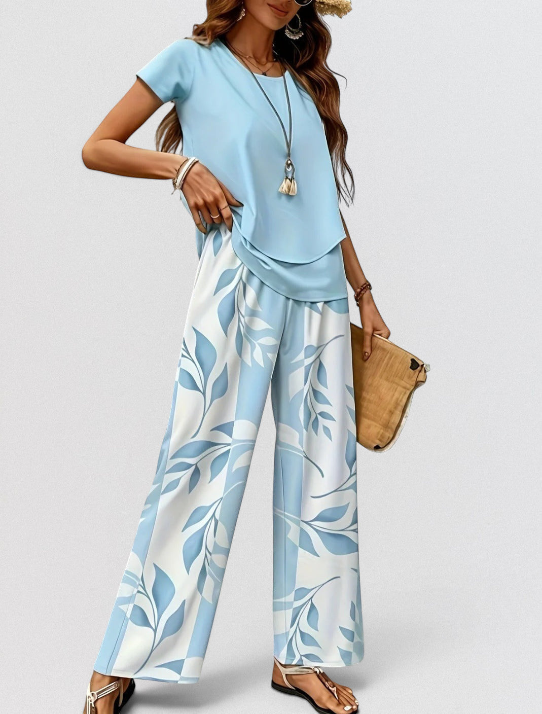 ZOFIA ATELIER light blue polyester top and wide-leg pants set with a blue and white leaf print.
