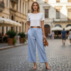 ZOFIA ATELIER light blue cotton-linen wide-leg cropped pants with pockets, worn by a model on a cobblestone street.