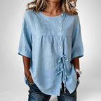 ZOFIA ATELIER light blue ice hemp asymmetric lace-up shirt with princess sleeves and button closure.