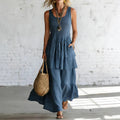 ZOFIA ATELIER blue linen sleeveless tiered maxi dress with pockets and relaxed fit.