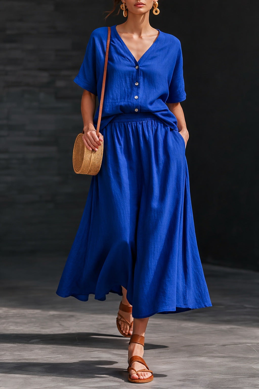 ZOFIA ATELIER BOGUMIŁA blue linen V-neck short sleeve button-up top and flowing maxi skirt two-piece set.