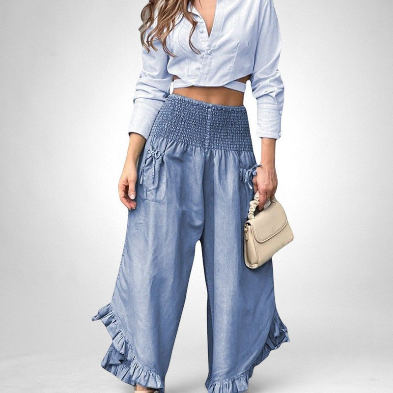ZOFIA ATELIER light blue long sleeve cropped top with smocked high-waisted wide-leg pants featuring ruffle hems.
