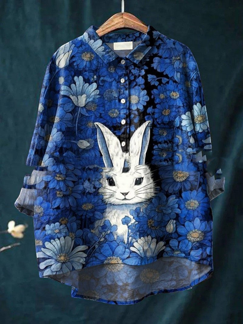 ZOFIA ATELIER blue spandex shirt with a vintage animal print of a white rabbit surrounded by blue flowers. Sleeveless design.