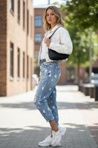 ZOFIA ATELIER blue denim trousers with white stars and distressed details, slim fit, straight cut.