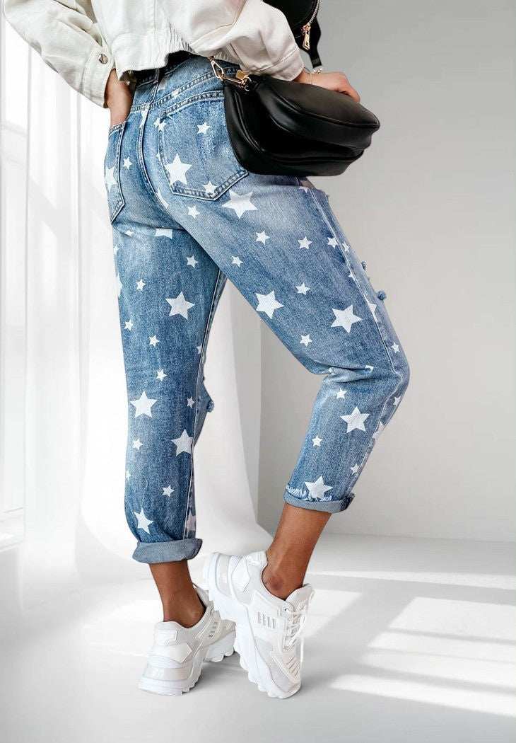ZOFIA ATELIER blue denim trousers with white star print and distressed details, slim fit, cuffed hems.