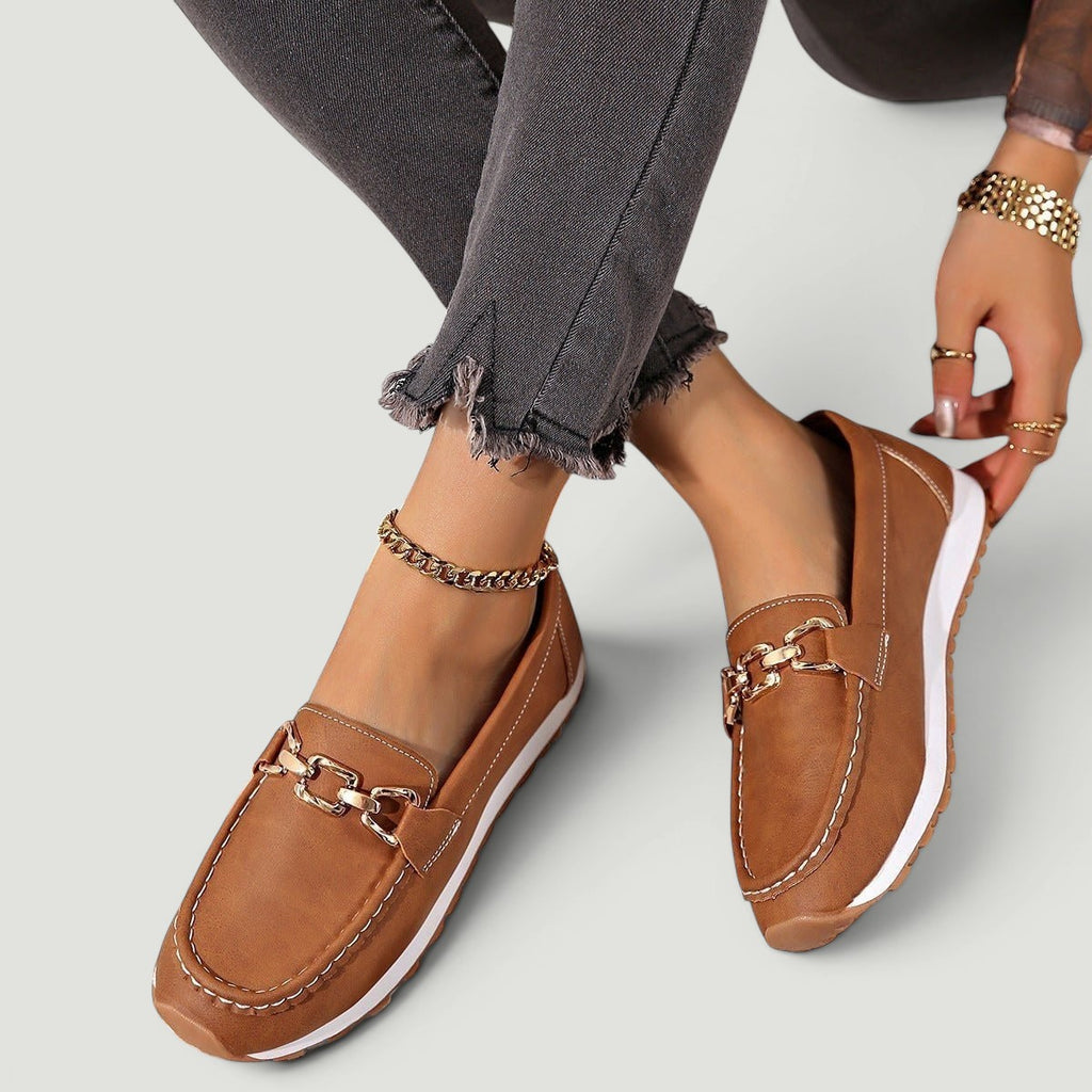 ZOFIA ATELIER brown faux leather chain platform loafers with white stitching and gold hardware.