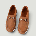 ZOFIA ATELIER brown faux leather loafers with gold chain detail and white stitching on a platform sole.
