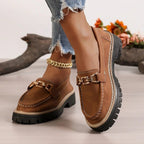 ZOFIA ATELIER brown faux suede chunky platform loafers with gold chain detail and white stitching.