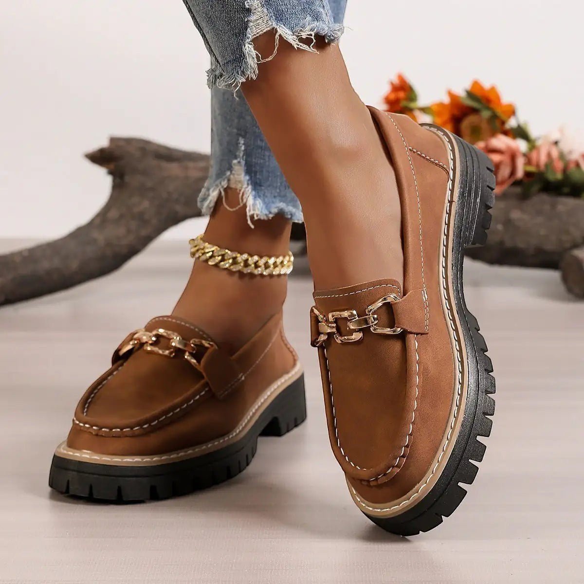 ZOFIA ATELIER brown faux suede chunky platform loafers with gold chain detail and white stitching.