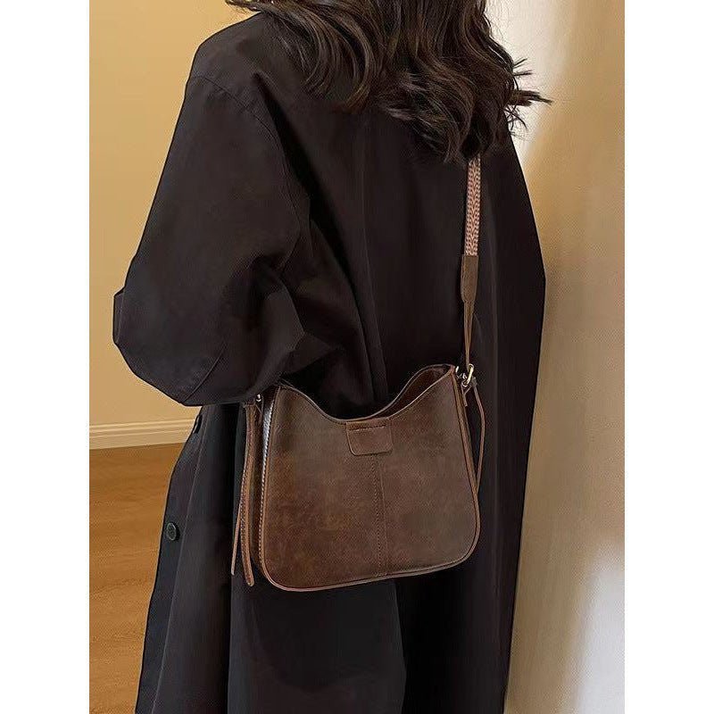 ZOFIA ATELIER brown corduroy crossbody bag with patchwork stitching and a woven strap, perfect for travel.