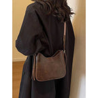 ZOFIA ATELIER brown corduroy crossbody bag with patchwork stitching and a woven strap, perfect for travel.