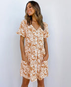 ZOFIA ATELIER brown mini dress with white floral print, V-neck, short sleeves, and button front.