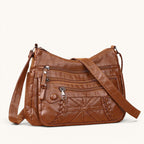 ZOFIA ATELIER brown PU leather messenger bag with multiple zippered pockets and braided detail.