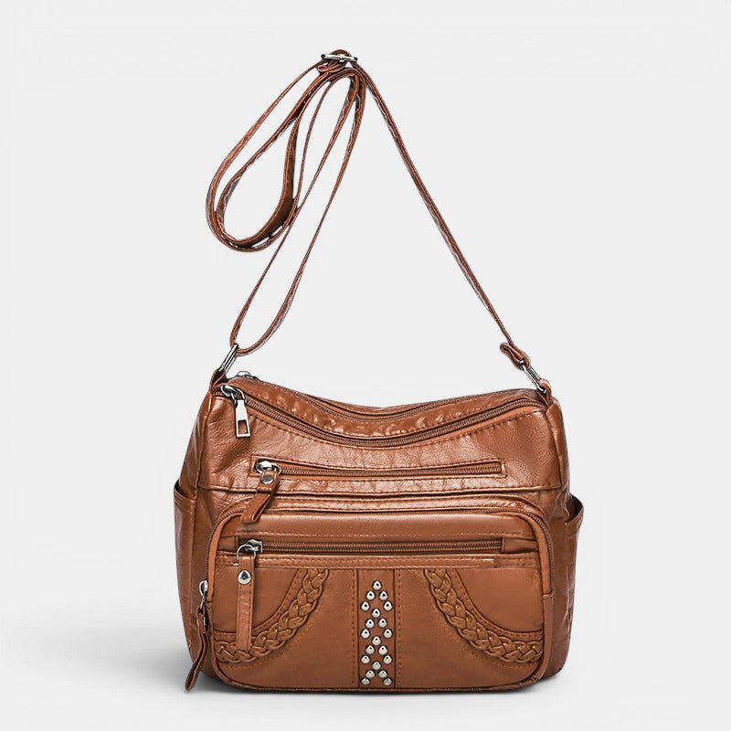 ZOFIA ATELIER GRAŻYNA multi-layer crossbody bag in brown PU leather with braided detail and silver studs.
