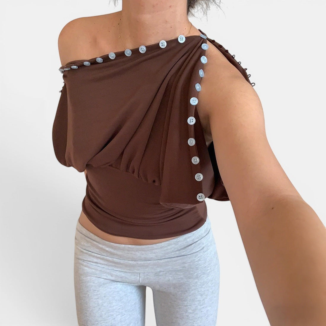 ZOFIA ATELIER warm brown sleeveless top with button details and defined waistline, made of 100% polyester.