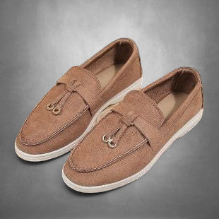 ZOFIA ATELIER brown suede loafers with tassel detail and white soles. Comfortable slip-on style.