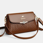 ZOFIA ATELIER brown PU leather crossbody bag with woven texture and floral clasp. Medium hardness.
