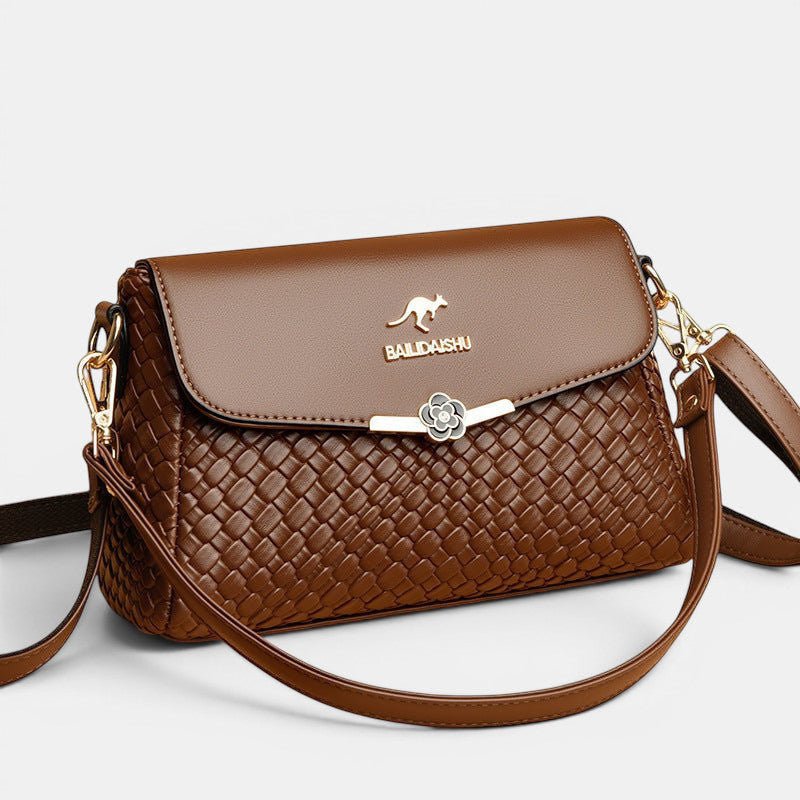 ZOFIA ATELIER brown PU leather crossbody bag with woven texture and floral clasp. Medium hardness.