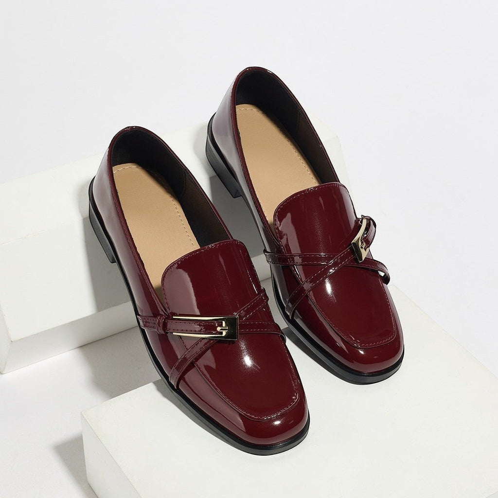 ZOFIA ATELIER burgundy patent leather square toe loafers with gold buckle detail.