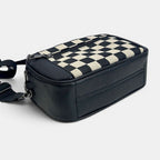 ZOFIA ATELIER black and cream chessboard pattern PU handbag with zipper closure and adjustable strap.
