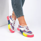 ZOFIA ATELIER white mesh sneakers with red and blue floral pattern and rainbow gradient sole.