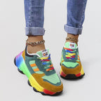 ZOFIA ATELIER colorful dad shoes with rainbow sole, green, orange, yellow, and red accents, and rainbow laces.