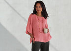 ZOFIA ATELIER coral linen blend relaxed fit blouse with wide sleeves and a boat neck, worn by a woman holding a mug.