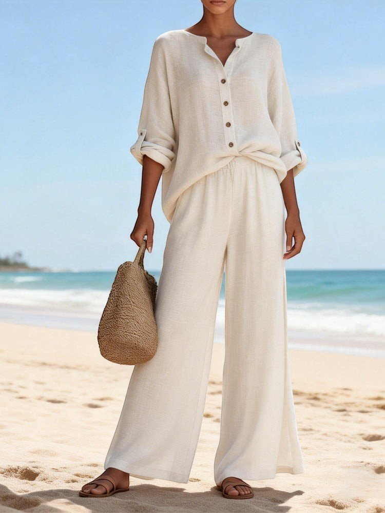 ZOFIA ATELIER cream cotton lounge set with V-neck long sleeve top and wide-leg pants on a beach.