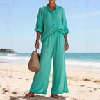 ZOFIA ATELIER turquoise cotton lounge set with V-neck long sleeve top and wide-leg pants on beach.