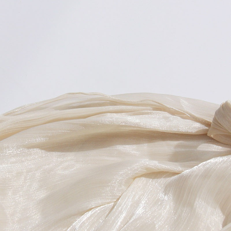 ZOFIA ATELIER cream cold-shoulder blouse with billowy sleeves and a flowy, asymmetric high-low hem.
