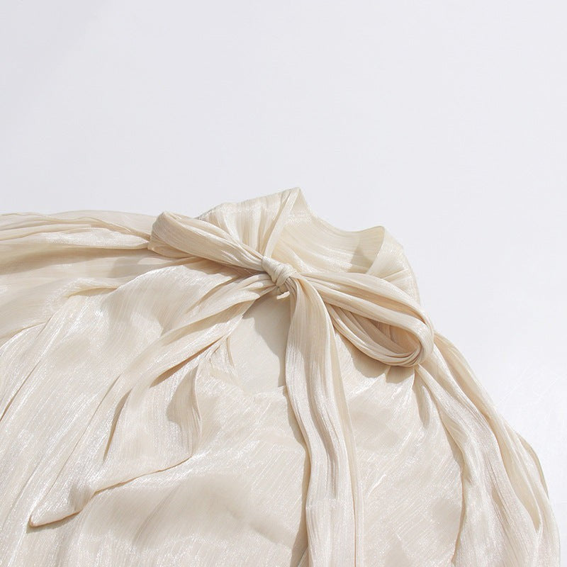 ZOFIA ATELIER cream cold-shoulder blouse with billowy sleeves and a tie detail.