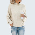 ZOFIA ATELIER cream chunky knit turtleneck sweater with relaxed fit and ribbed cuffs and hem.