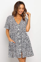 ZOFIA ATELIER black and white dalmatian print mini dress with V-neck, short sleeves, and button front. Loose waist and pockets.