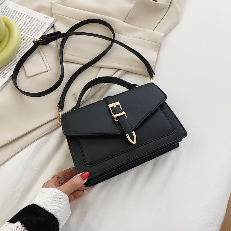 ZOFIA ATELIER Ewerina black PU leather crossbody bag with gold buckle detail and adjustable strap.