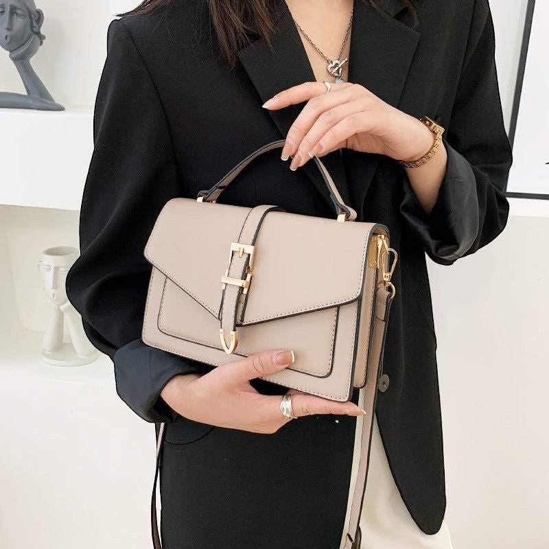 ZOFIA ATELIER Ewerina crossbody bag in beige PU leather with gold buckle detail. Features a structured design and a front flap closure.