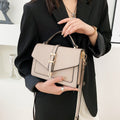 ZOFIA ATELIER Ewerina crossbody bag in beige PU leather with gold buckle detail and adjustable strap.