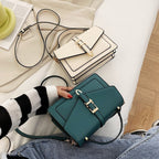 ZOFIA ATELIER Ewerina crossbody bag in teal PU leather with gold hardware and contrast trim. Features a structured design and a flap closure.