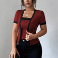 ZOFIA ATELIER faux two-piece cardigan in deep red with black trim, short sleeves, and square neckline.