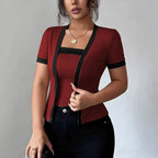 ZOFIA ATELIER faux two-piece cardigan in deep red with black trim, short sleeves, and square neckline.